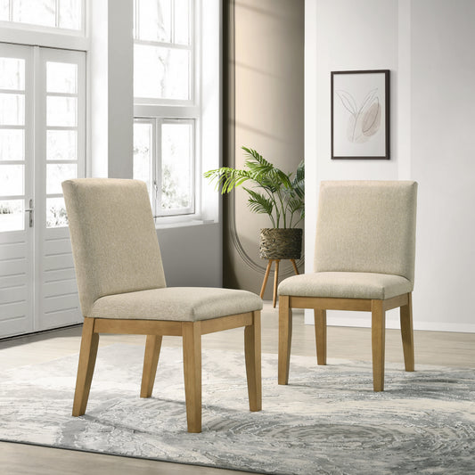 Two beige upholstered dining chairs with natural wood legs in a modern dining room setting