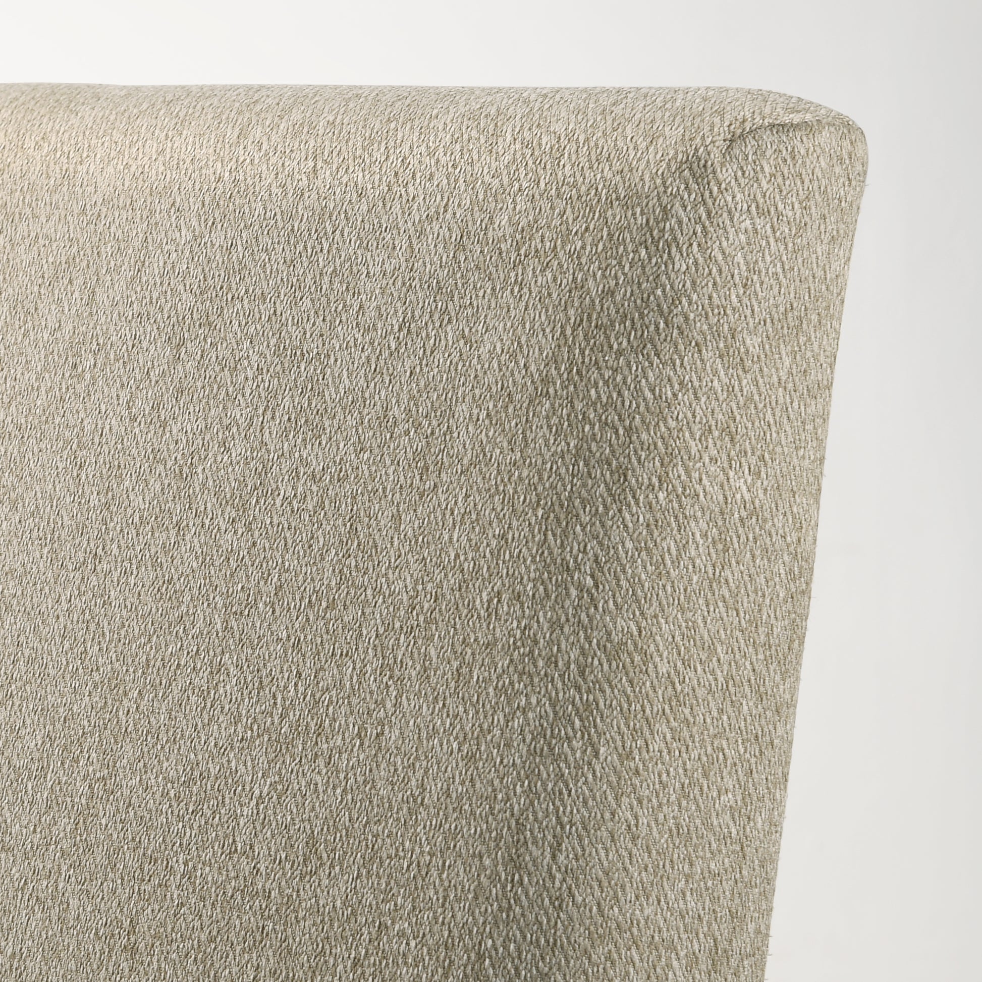 Closeup of a light tan woven fabric showing intricate texture