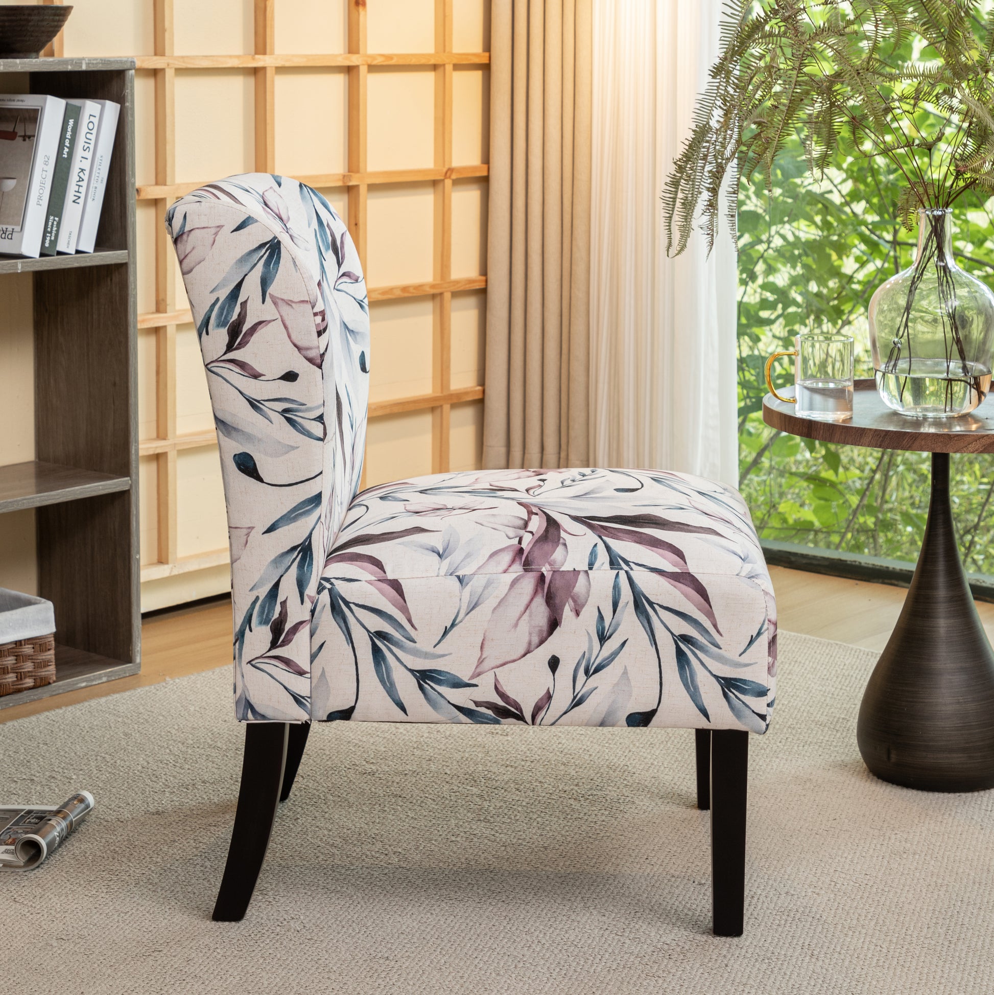Upholstered accent chair with a botanical leaf print in beige teal and plum hues