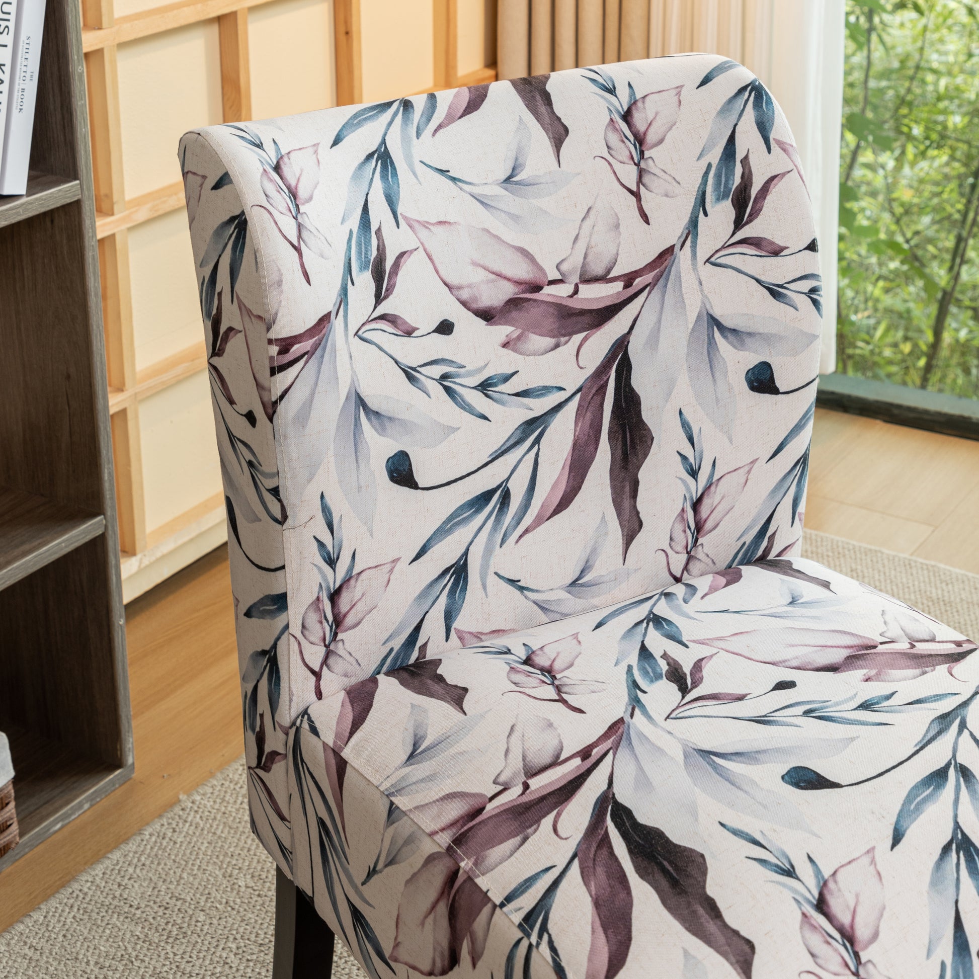 Accent chair with a watercolor floral print in muted blues and purples on an offwhite background