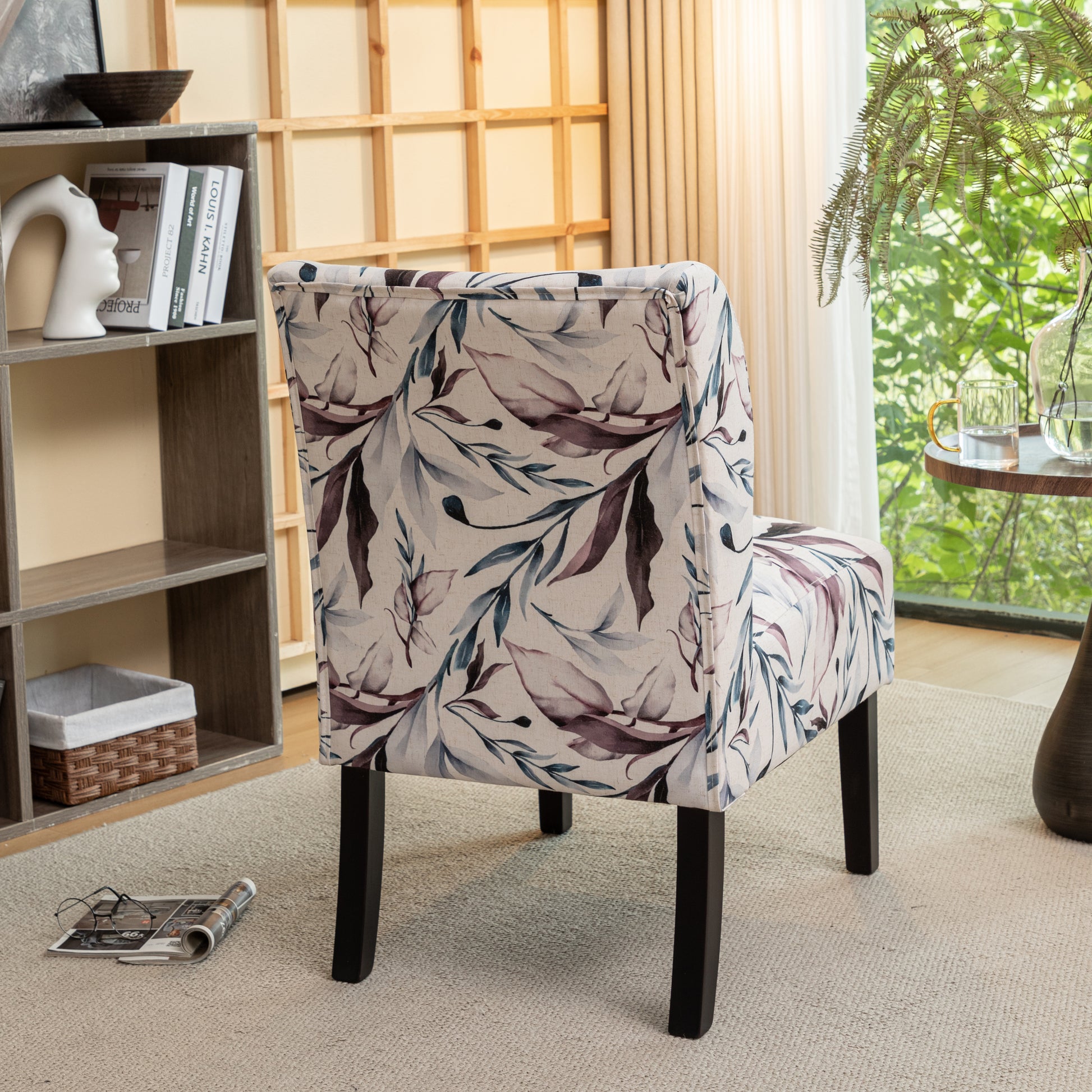 Accent chair with a botanical print fabric in cream plum and teal tones