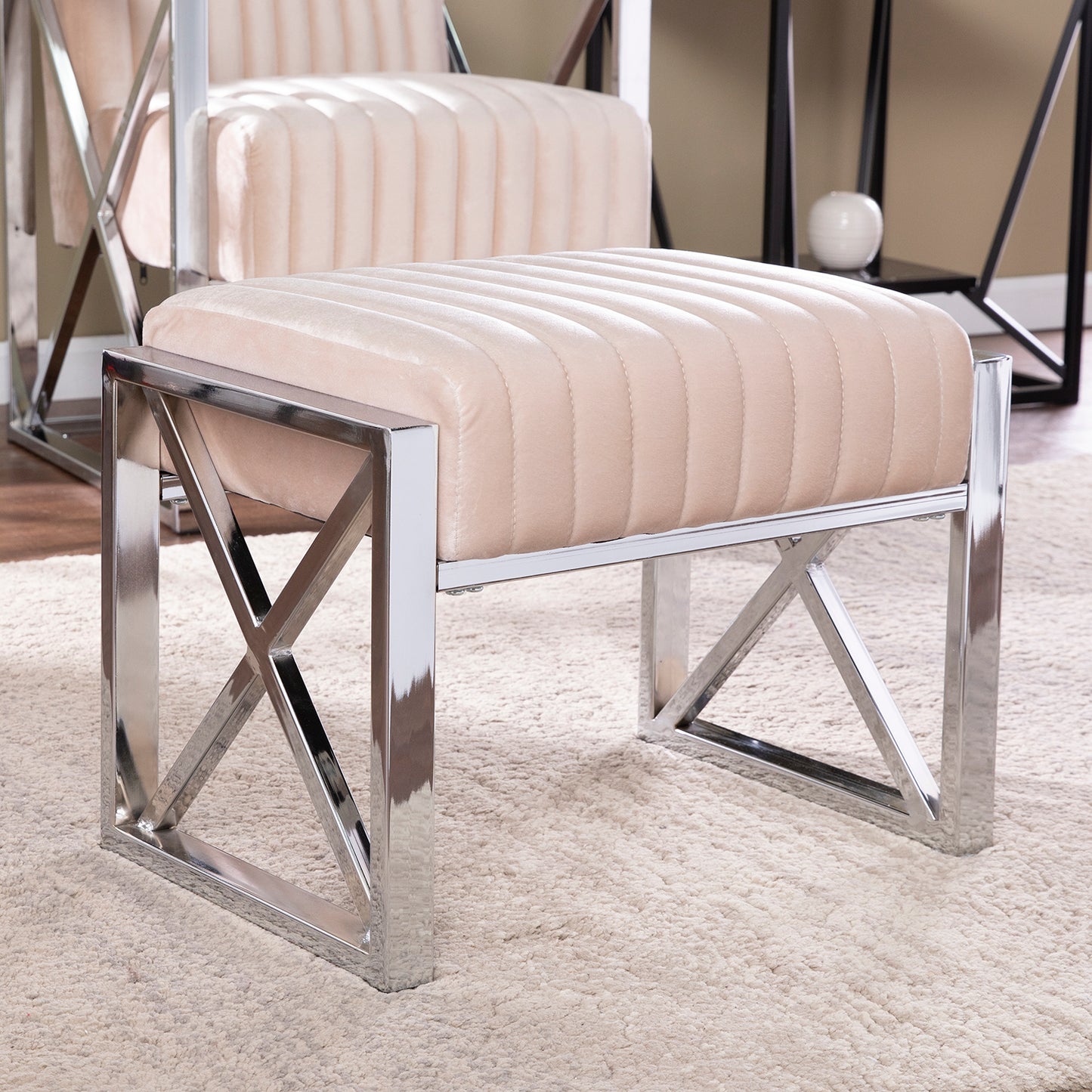 Beige velvet upholstered ottoman with chrome geometric base
