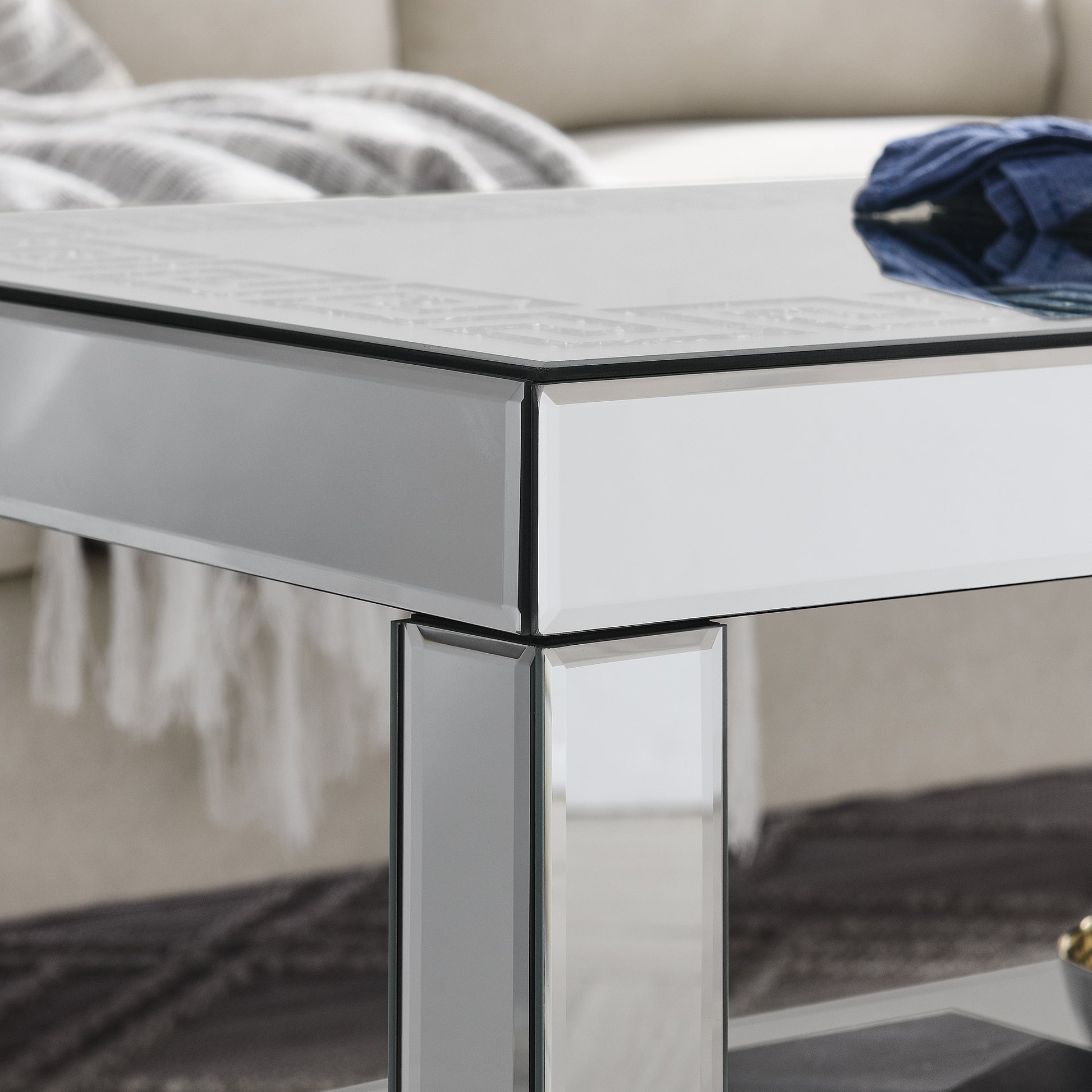 Glamorous mirrored coffee table with a detailed geometric border on top