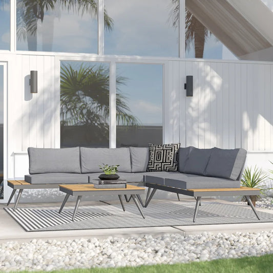 Modern grey sectional outdoor sofa with wooden accents and black patterned pillow