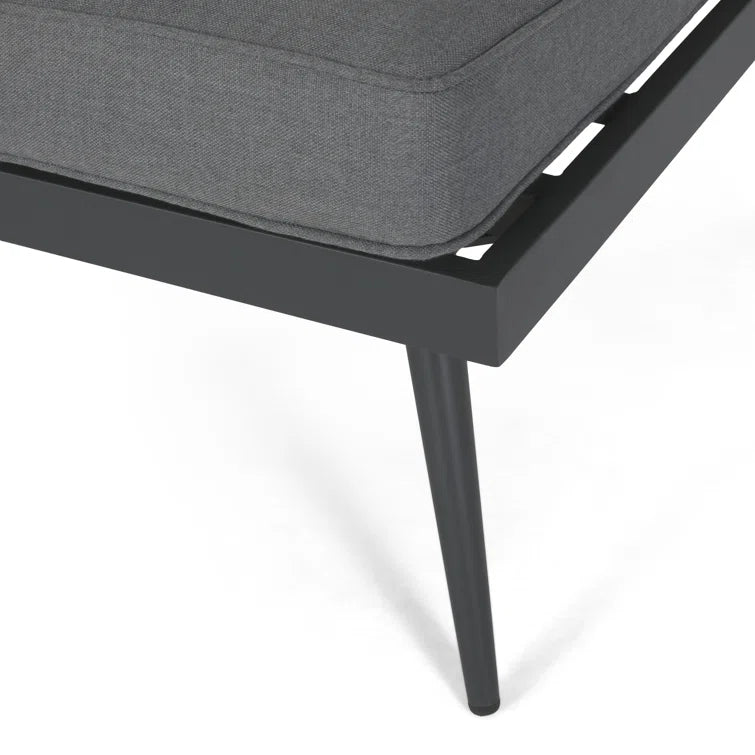 Closeup of dark grey outdoor sectional sofa cushion and black metal frame