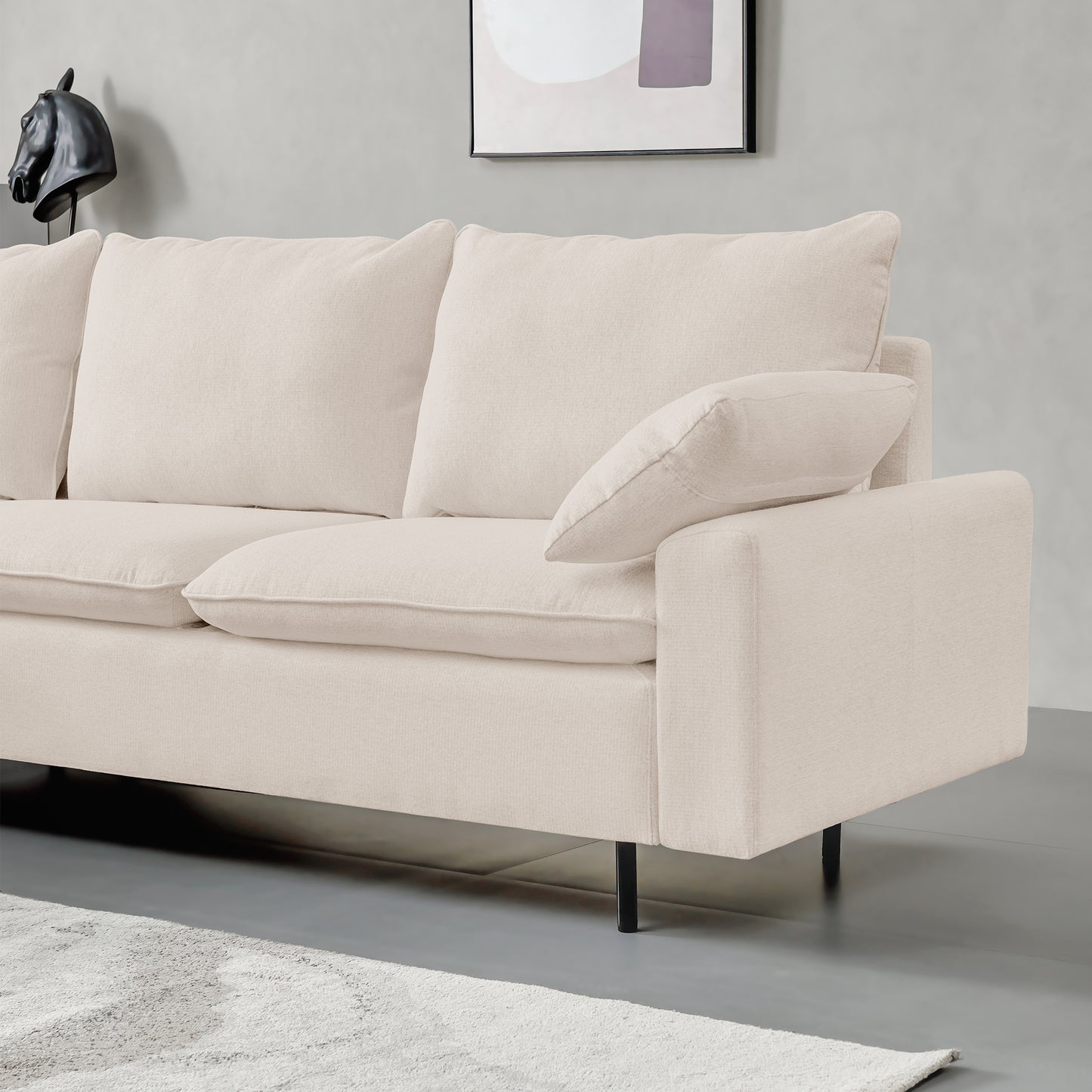Cream fabric sectional sofa with plush cushions and modern black legs