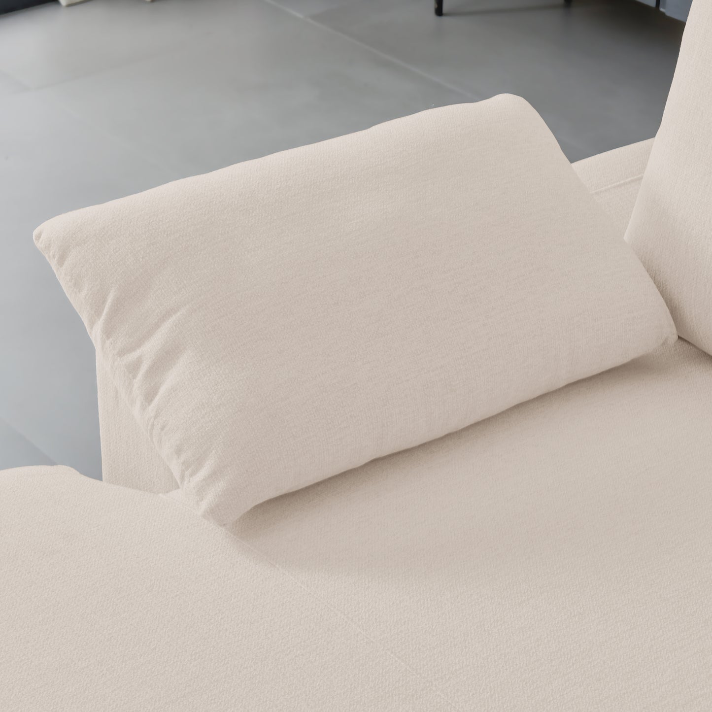 Closeup of a textured cream fabric on a comfortable throw pillow for a sofa