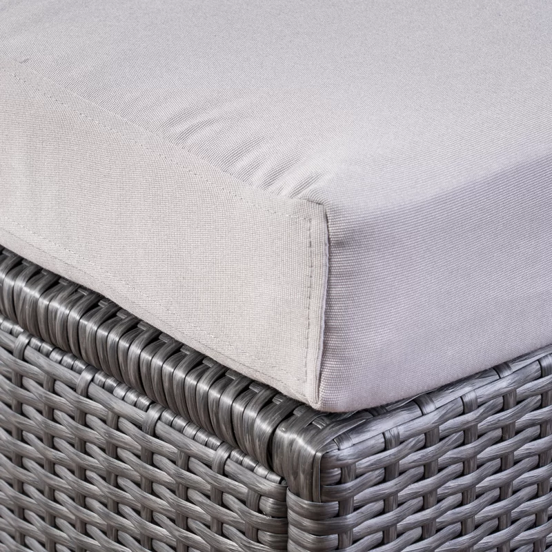 Closeup of a light grey outdoor furniture cushion on a wicker base
