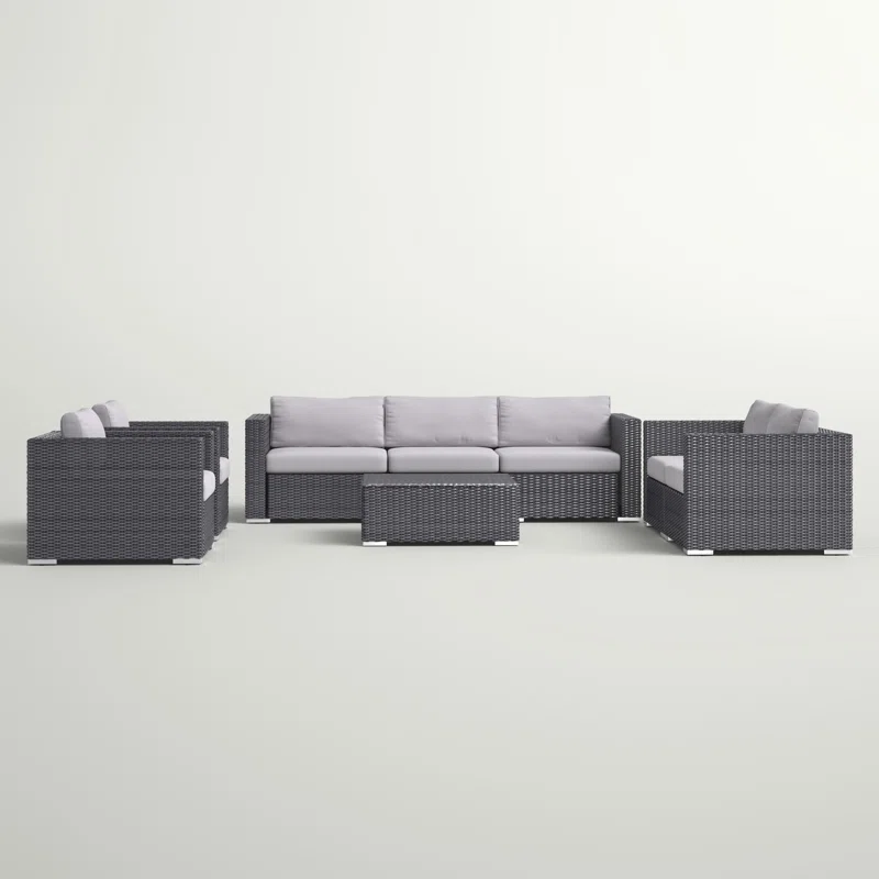 Dark gray wicker sectional outdoor furniture set with light gray cushions and coffee table