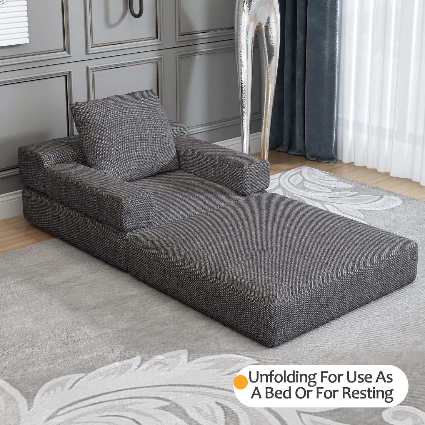 Contemporary dark gray chaise lounge with upholstered fabric and square arms for stylish relaxation