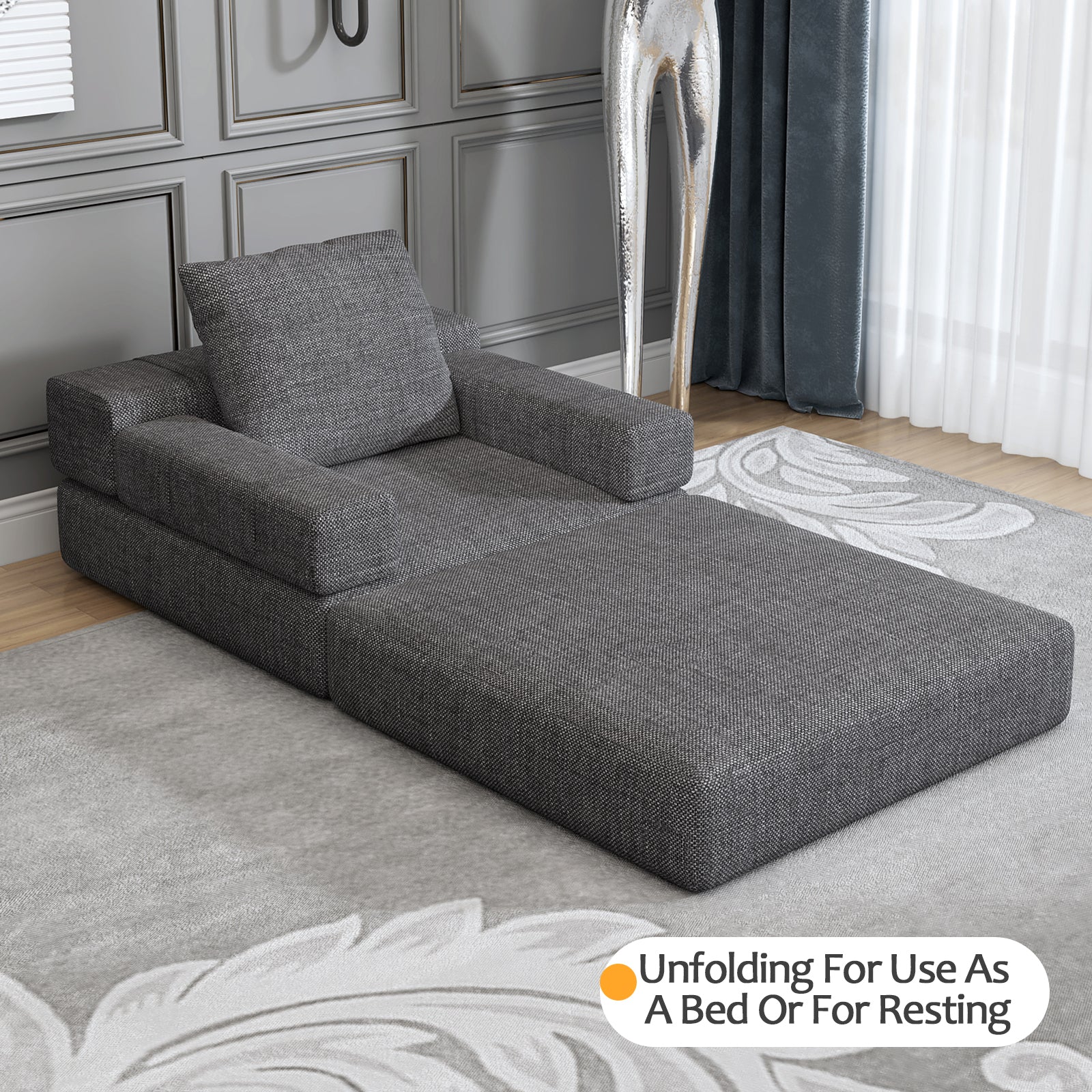 Contemporary dark gray chaise lounge with upholstered fabric and square arms for stylish relaxation