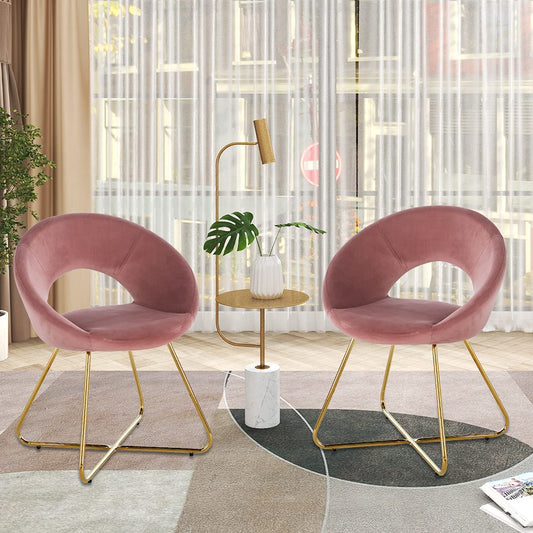 Two blush pink velvet accent chairs with gold metal legs ideal for modern living rooms