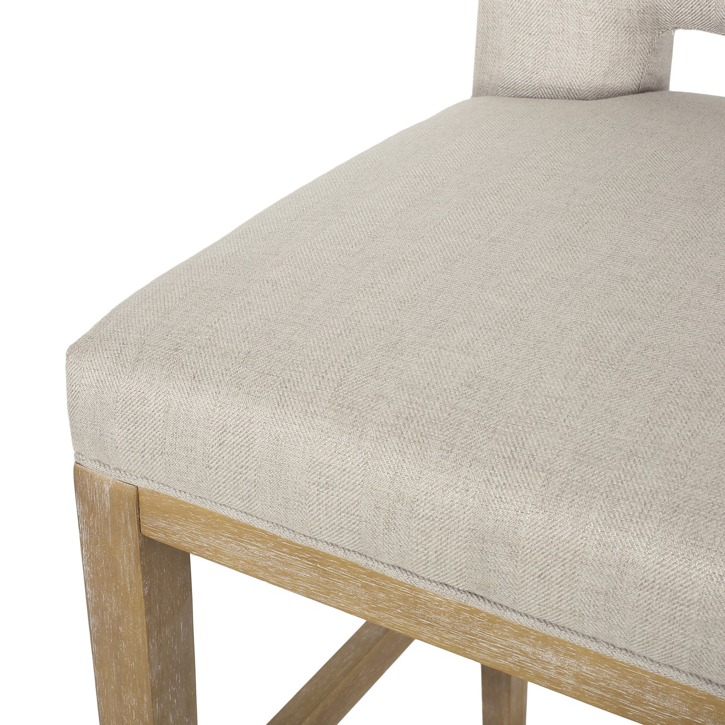 Close up of a neutral woven fabric seat cushion on a light wood frame counter stool