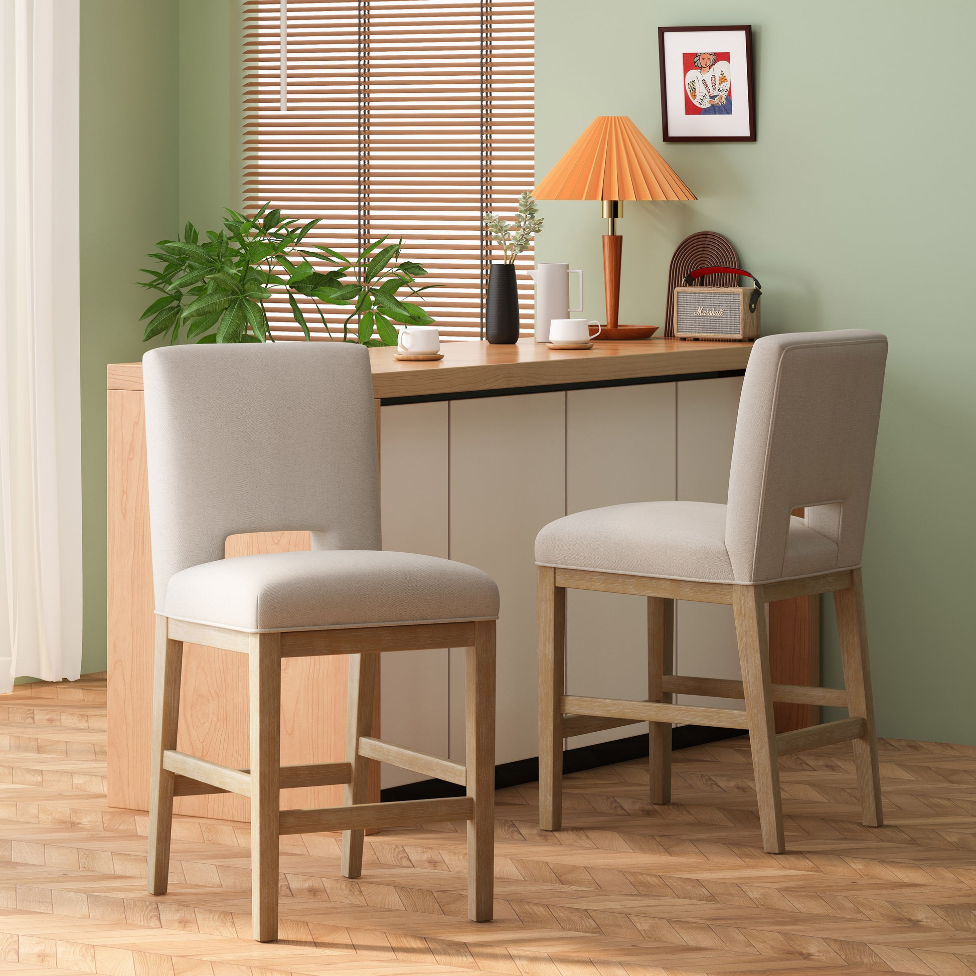 Two natural wood bar stools with beige upholstery and cutout backs in a modern kitchen