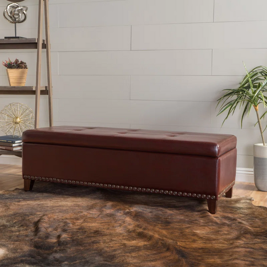 Tufted brown leather storage ottoman with nailhead trim perfect for entryway seating