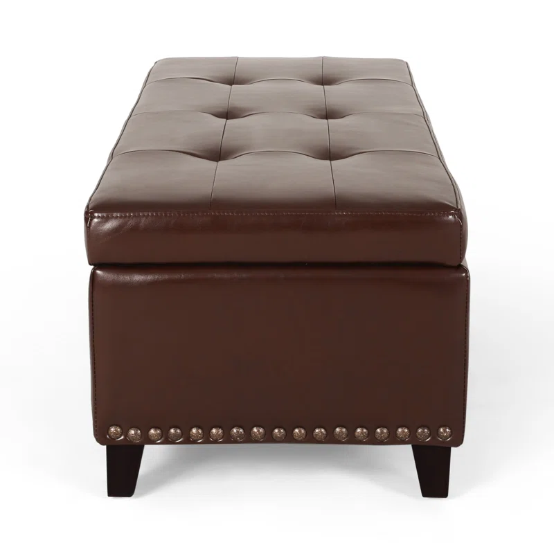 Brown faux leather storage ottoman with tufted top and nailhead trim