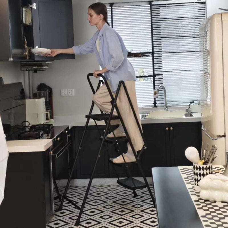 Folding kitchen step stool with black metal frame and nonslip treads