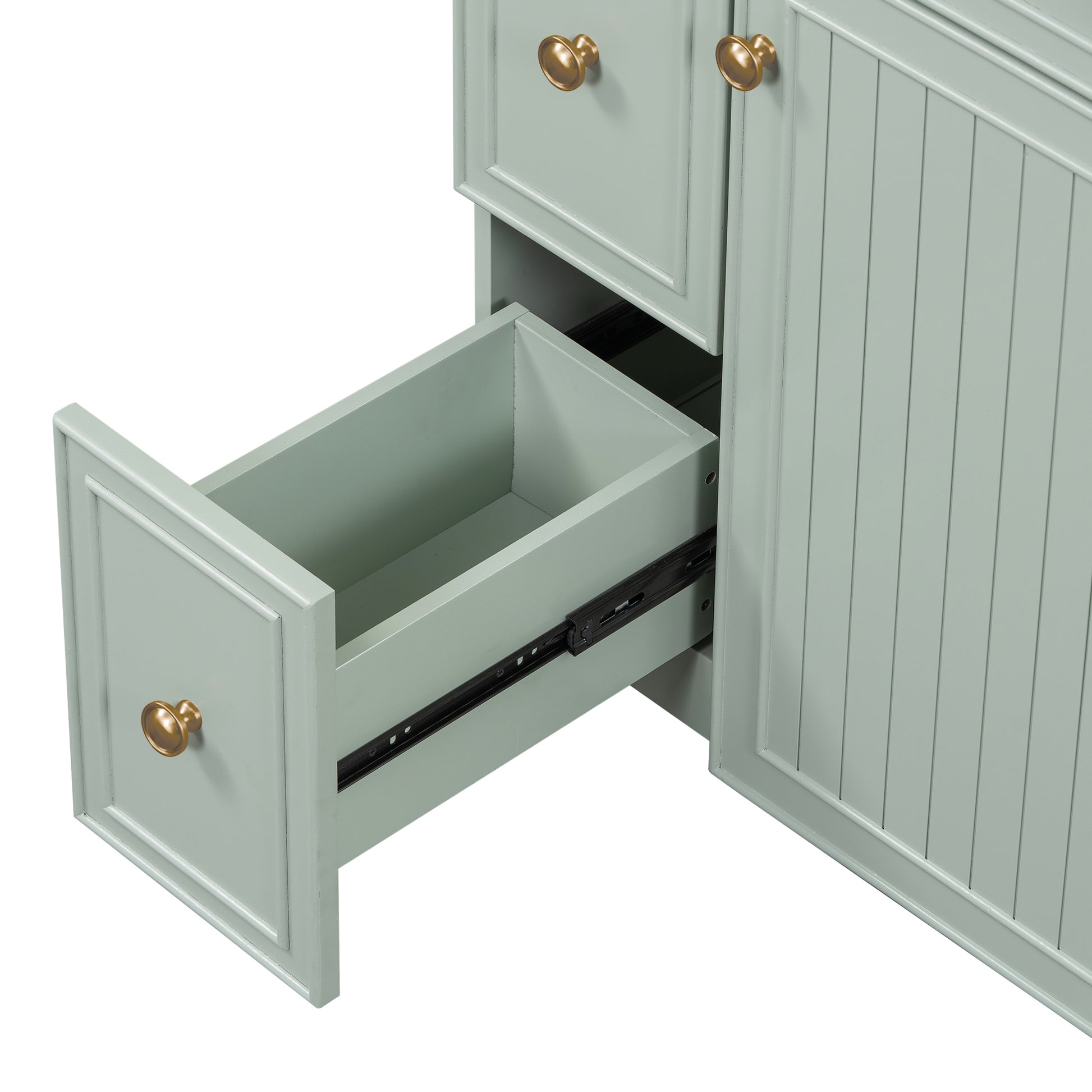 Soft sage green vanity cabinet with an open drawer and brass hardware detail perfect for bathrooms