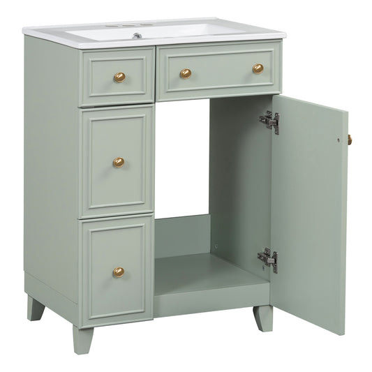 Sage green bathroom vanity with white ceramic top and gold knobs