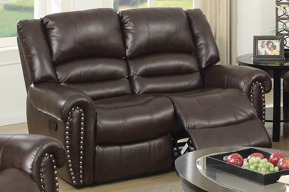 Dark brown leather reclining loveseat with decorative nailhead trim for comfortable seating