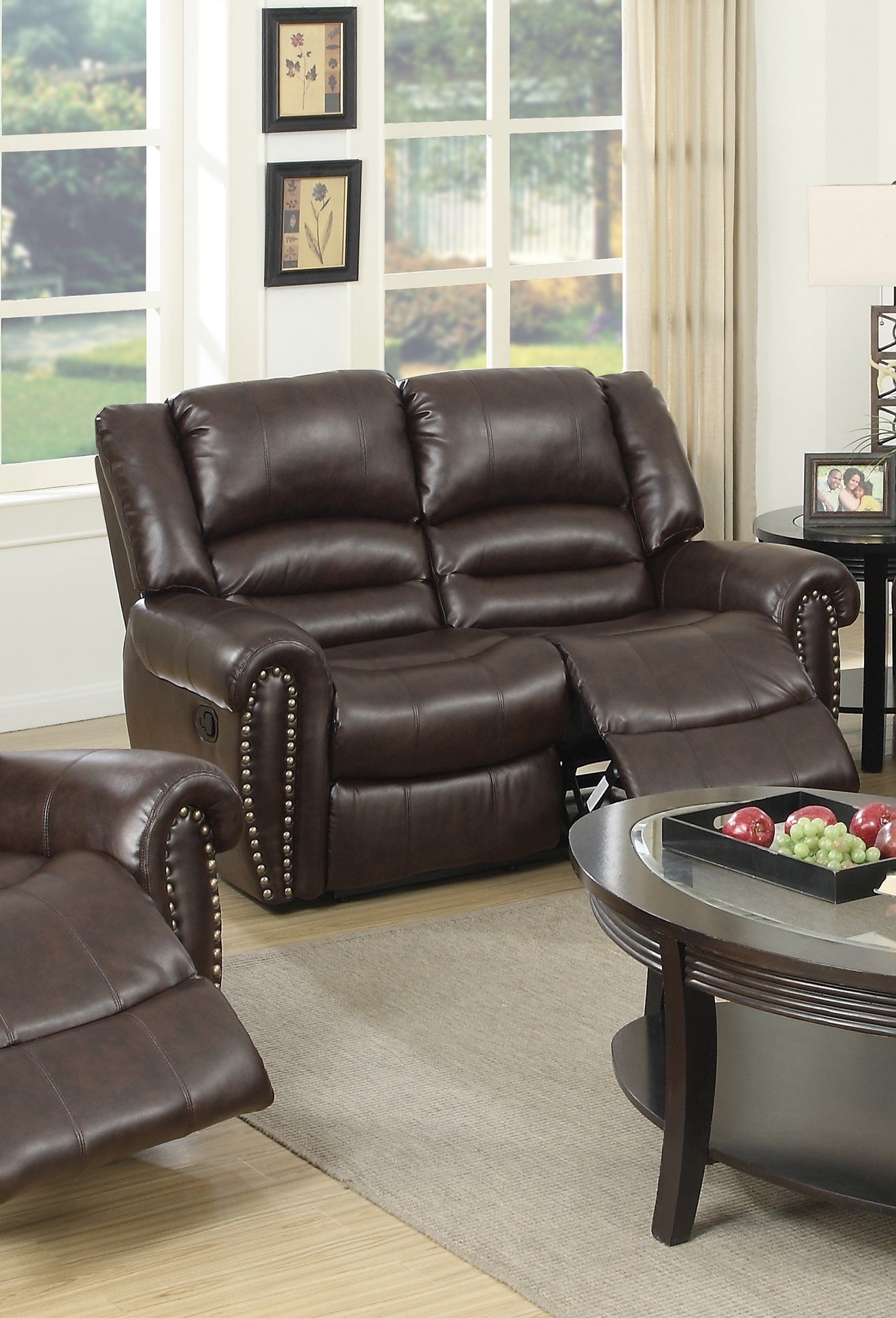Rich brown leather reclining loveseat with studded accents for a classic living room