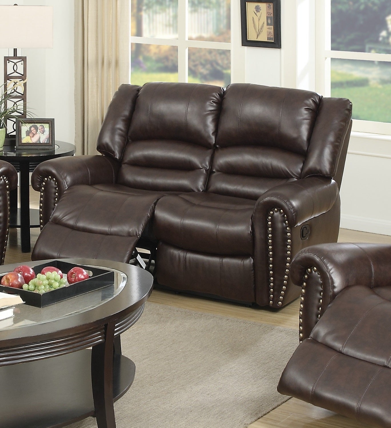 Brown leather loveseat recliner with decorative nailhead trim for cozy living rooms