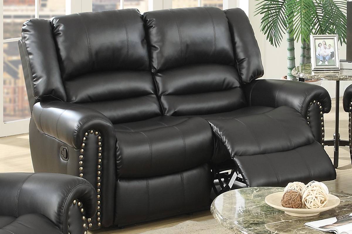 Black leather twoseater recliner sofa with studded armrests and plush cushioning for ultimate comfort