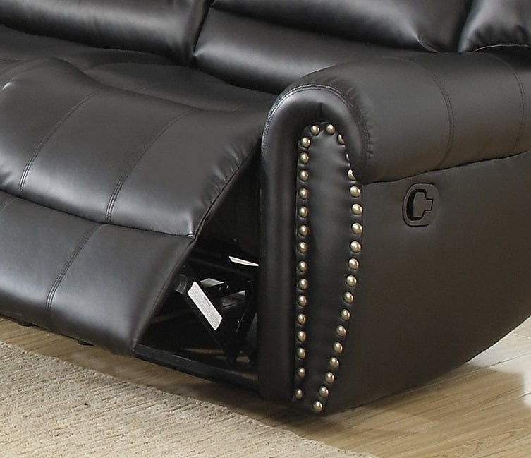 Black leather recliner sofa with tufted cushioning and decorative nailhead trim detail