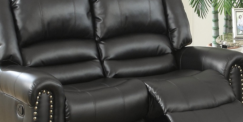 Black leather recliner sofa with tufted cushioning and studded armrests for ultimate comfort