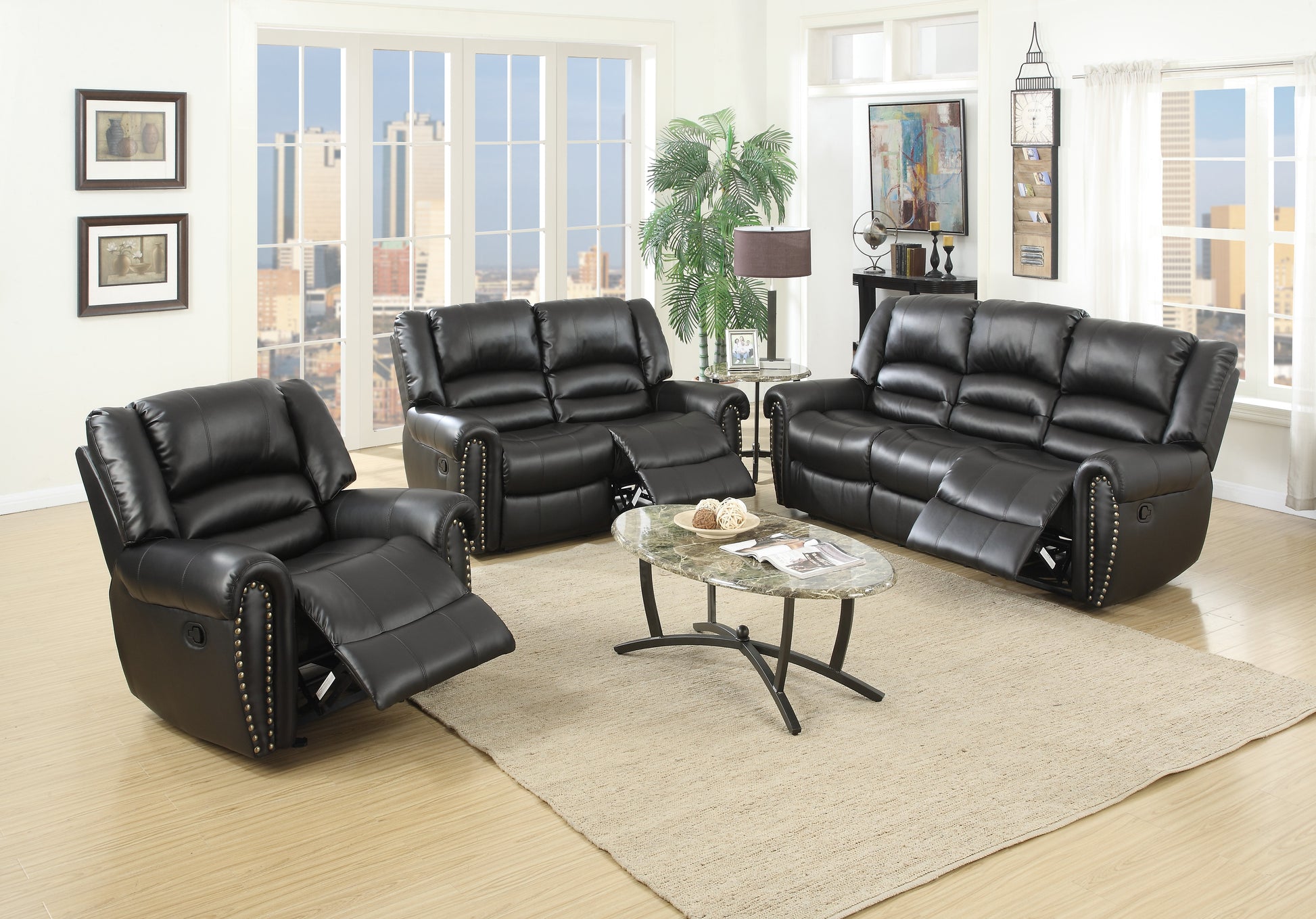 Black faux leather reclining sofa with studded accents and plush cushioning