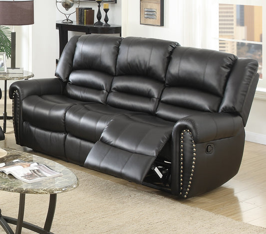 Black leather reclining sofa with plush cushioning and decorative nailhead trim for a modern living room