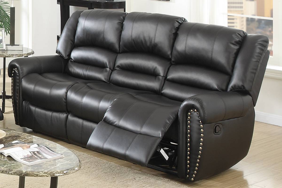 Black faux leather recliner sofa with silver nailhead trim and plush cushions