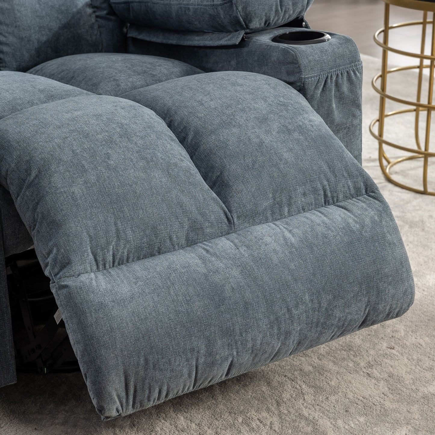 Plush blue fabric recliner with builtin cup holder ideal for home theater seating