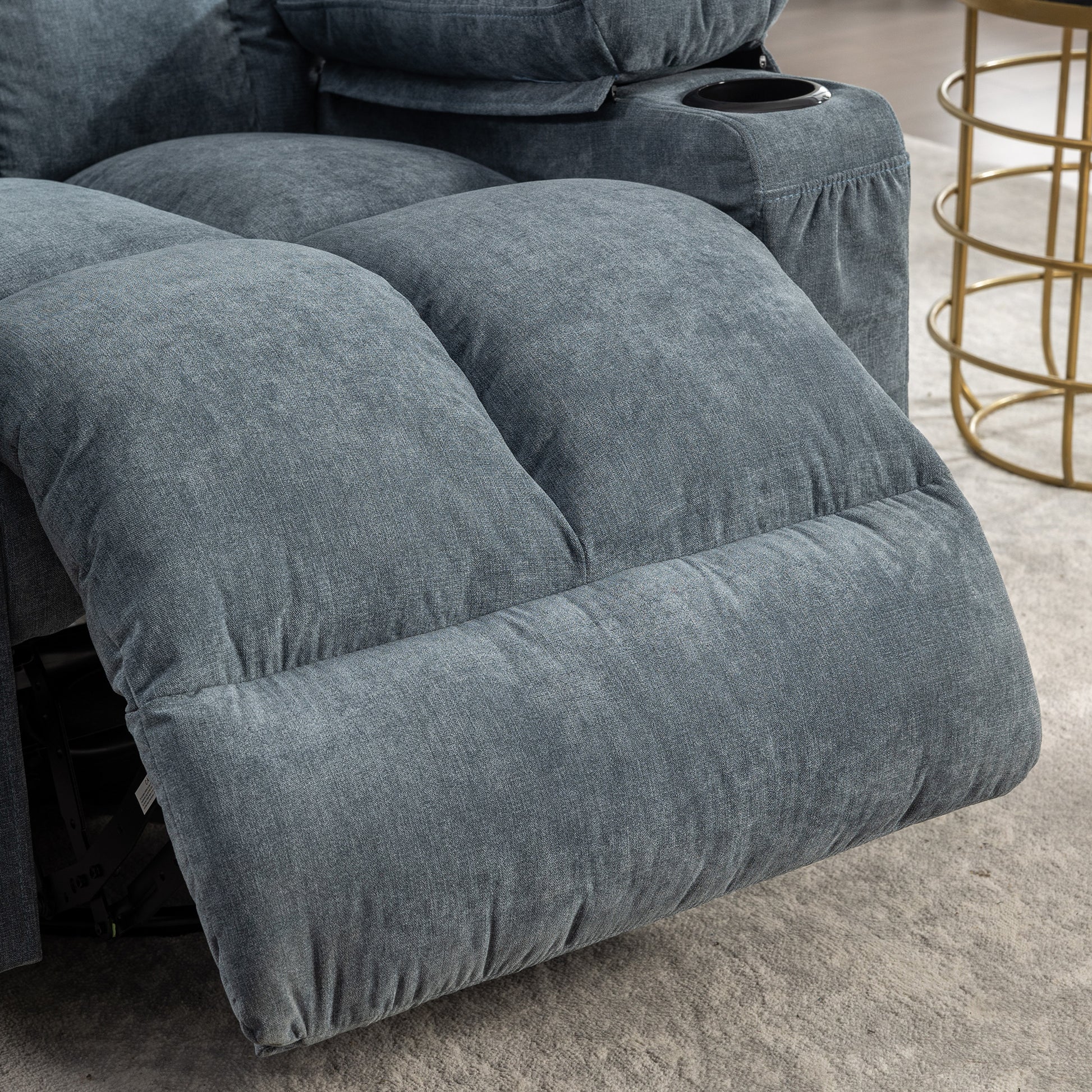 Plush blue fabric recliner with builtin cup holder ideal for home theater seating
