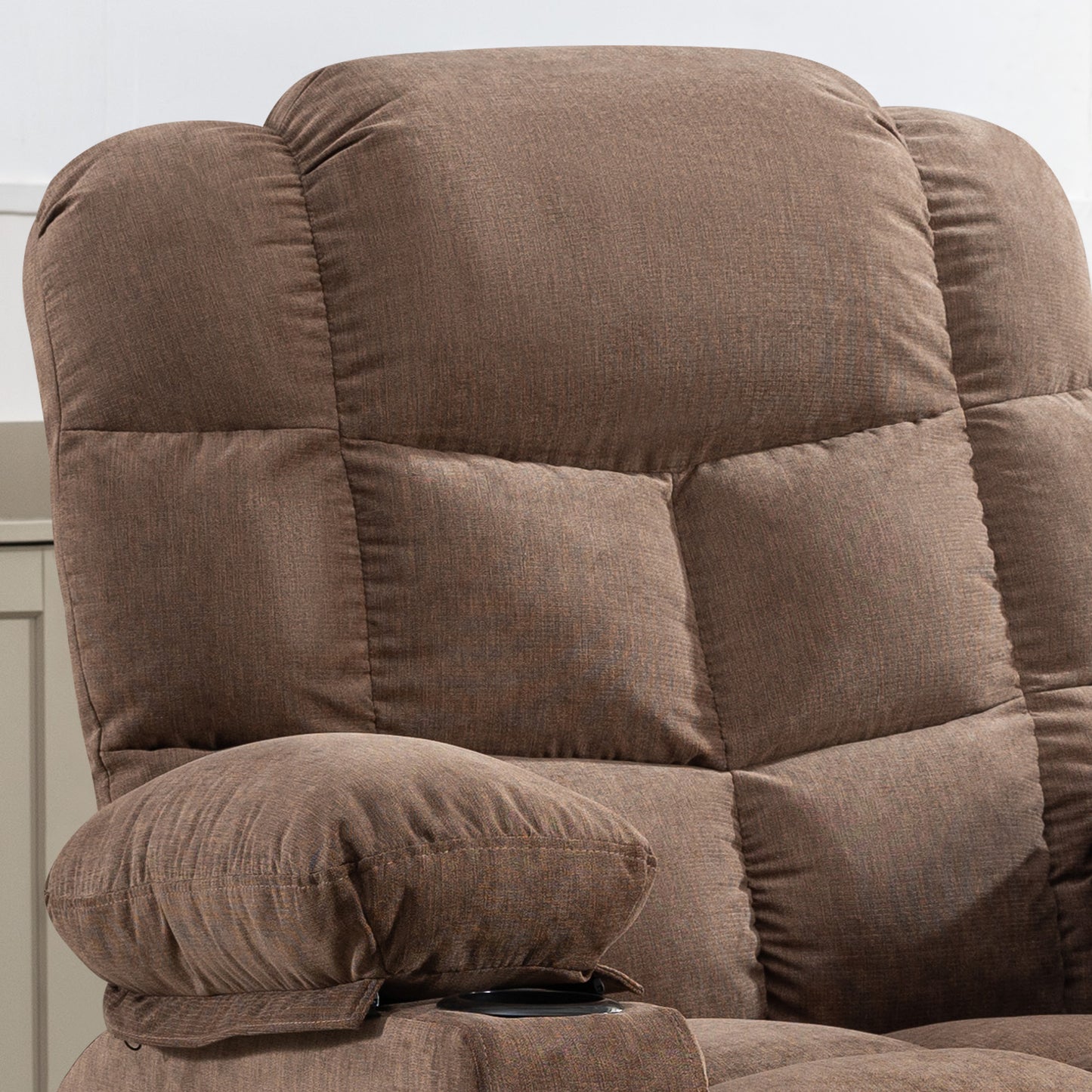 Plush brown fabric recliner seat with quilted padding and integrated cup holder