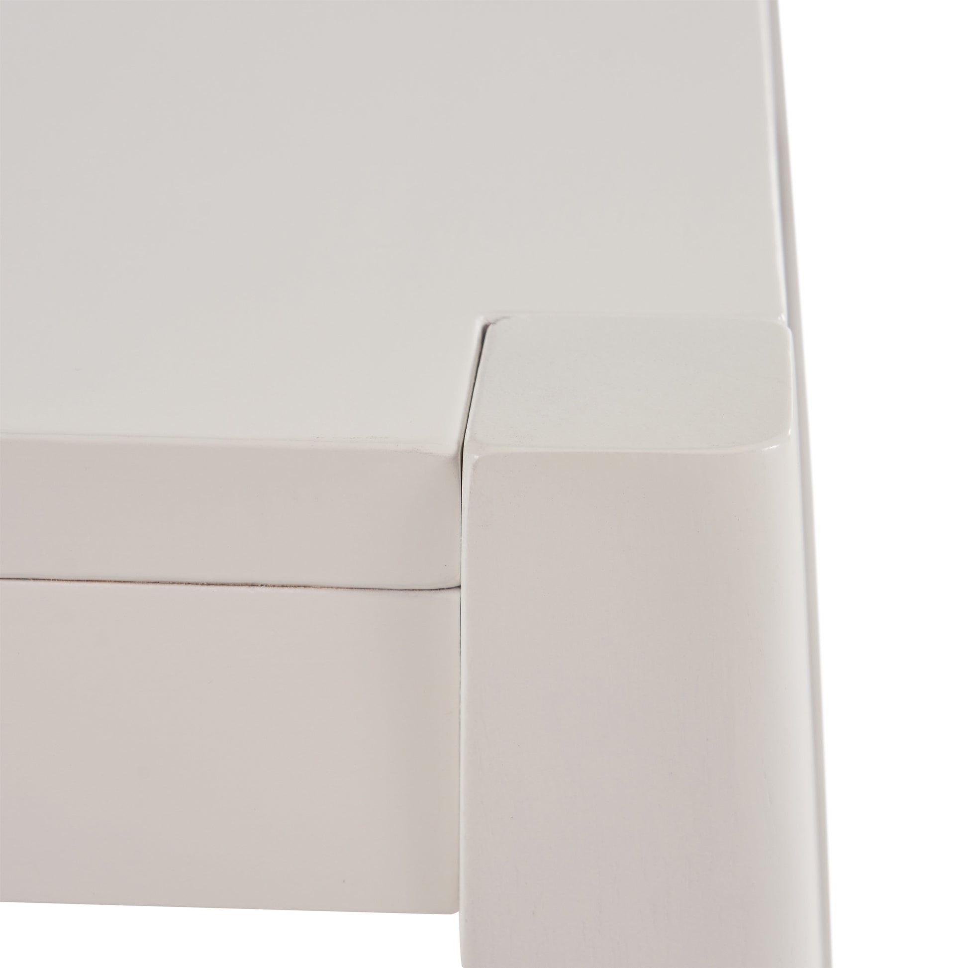White modern bedside table corner detail with smooth edges