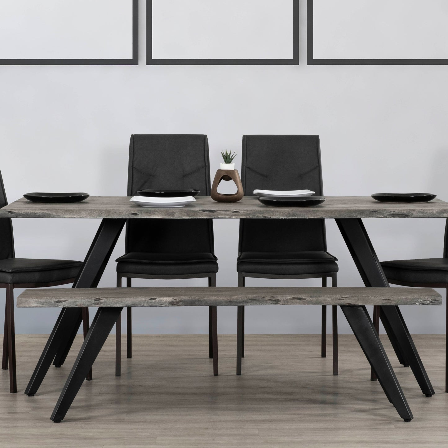Rustic wood dining table with black metal legs and black chairs