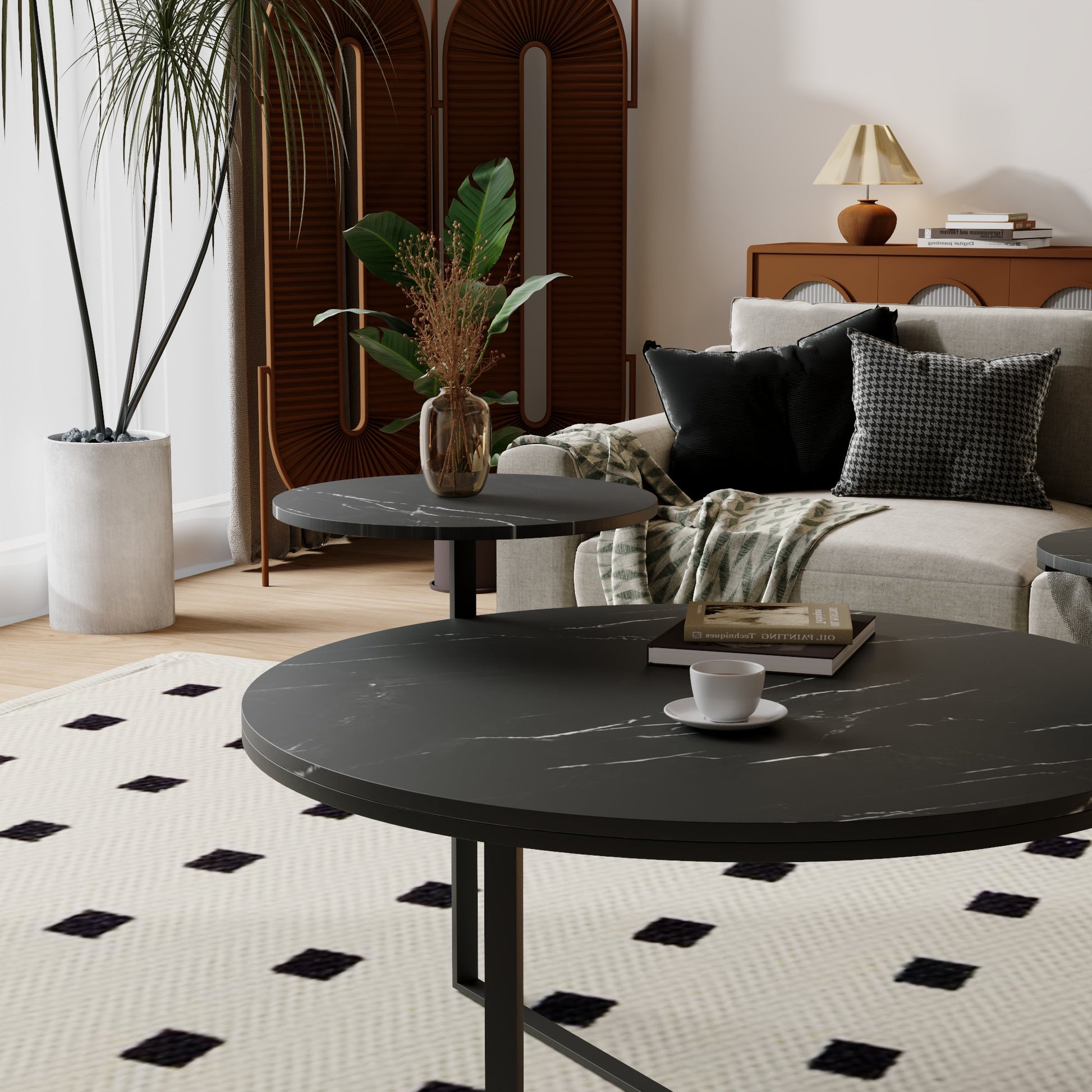 Round black marble coffee table with a book and cup for modern living rooms