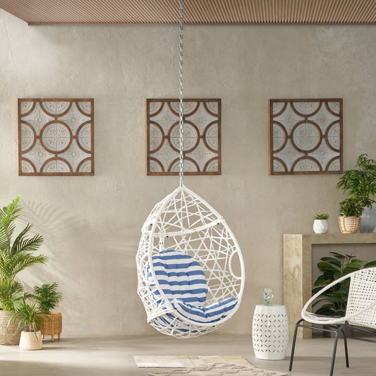 White wicker egg chair with blue striped cushion perfect for outdoor relaxation