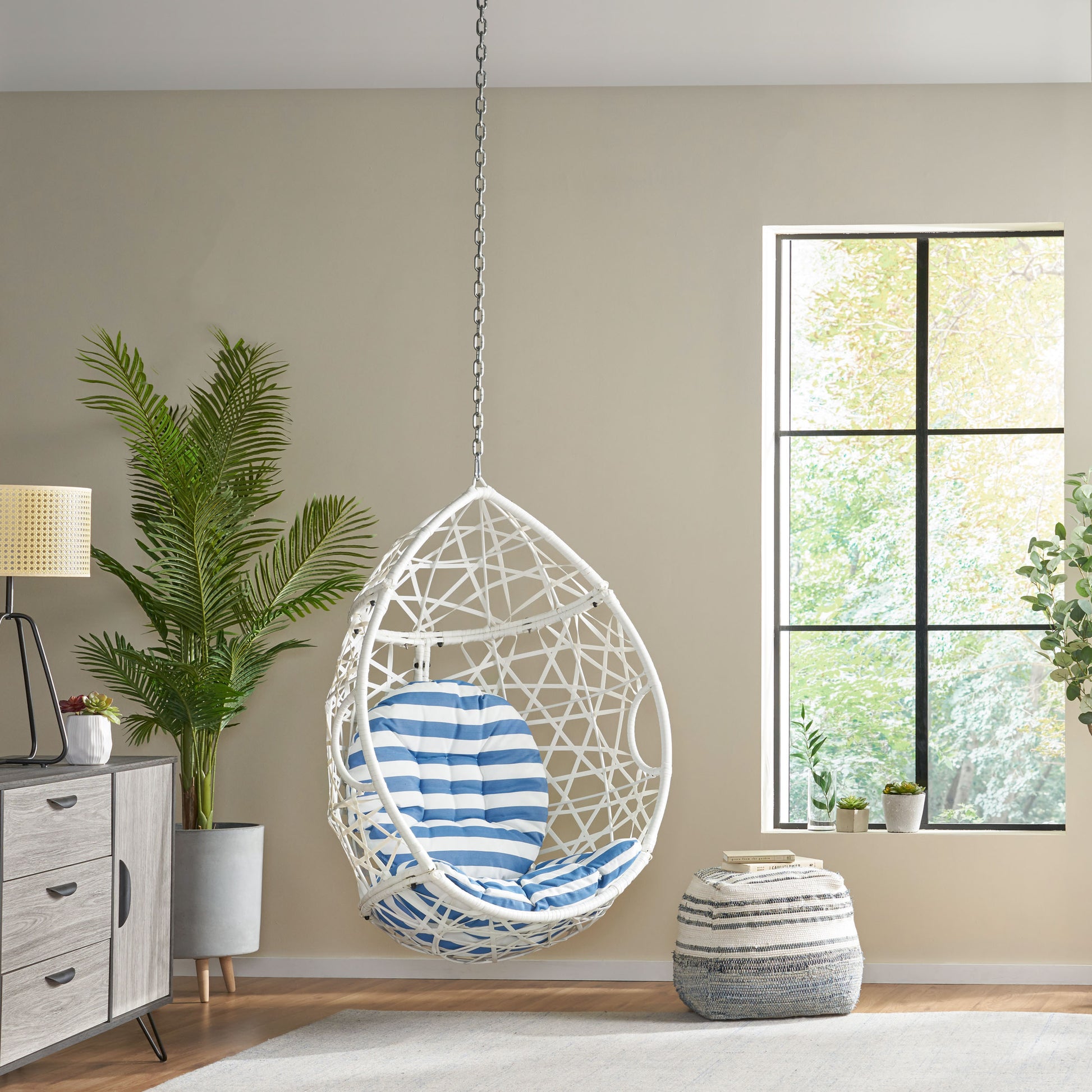 White wicker egg chair with blue striped cushion perfect for hanging indoors