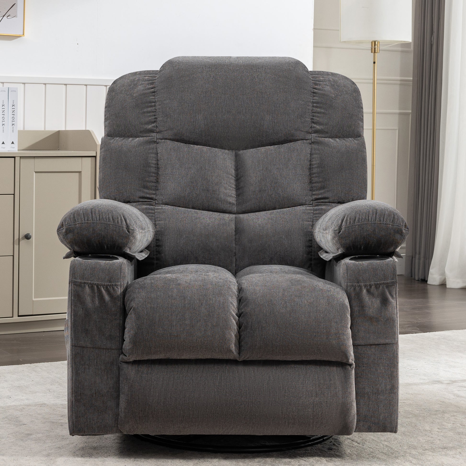 Padded charcoal gray fabric recliner chair with plush cushions and dual cup holders