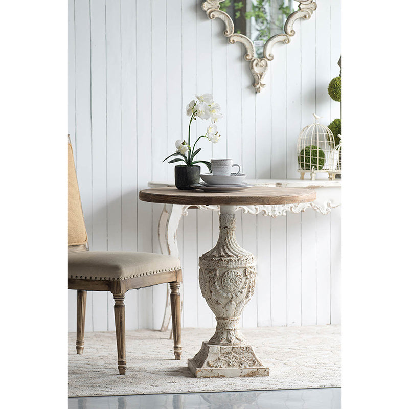 Ornate antique pedestal table with distressed white finish and wooden top