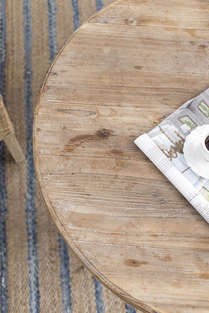 Rustic round wood table with a natural grain finish perfect for a cozy living room