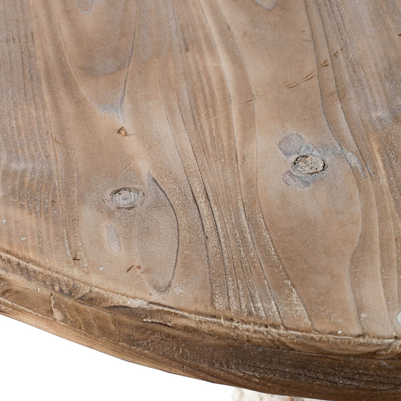 Closeup of weathered natural wood tabletop with prominent grain and knots