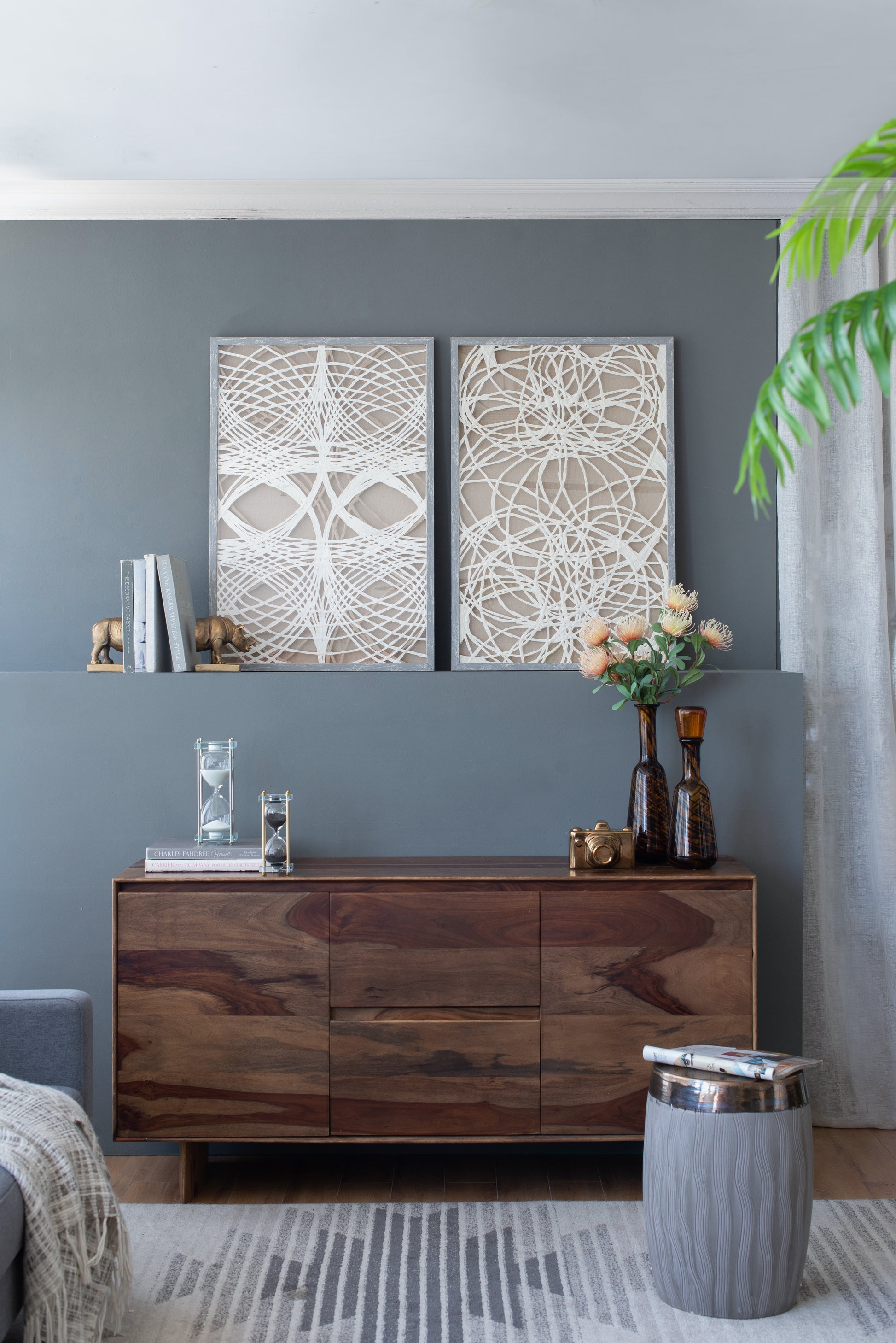 Wooden sideboard with drawers and decorative hourglasses gold camera and vases