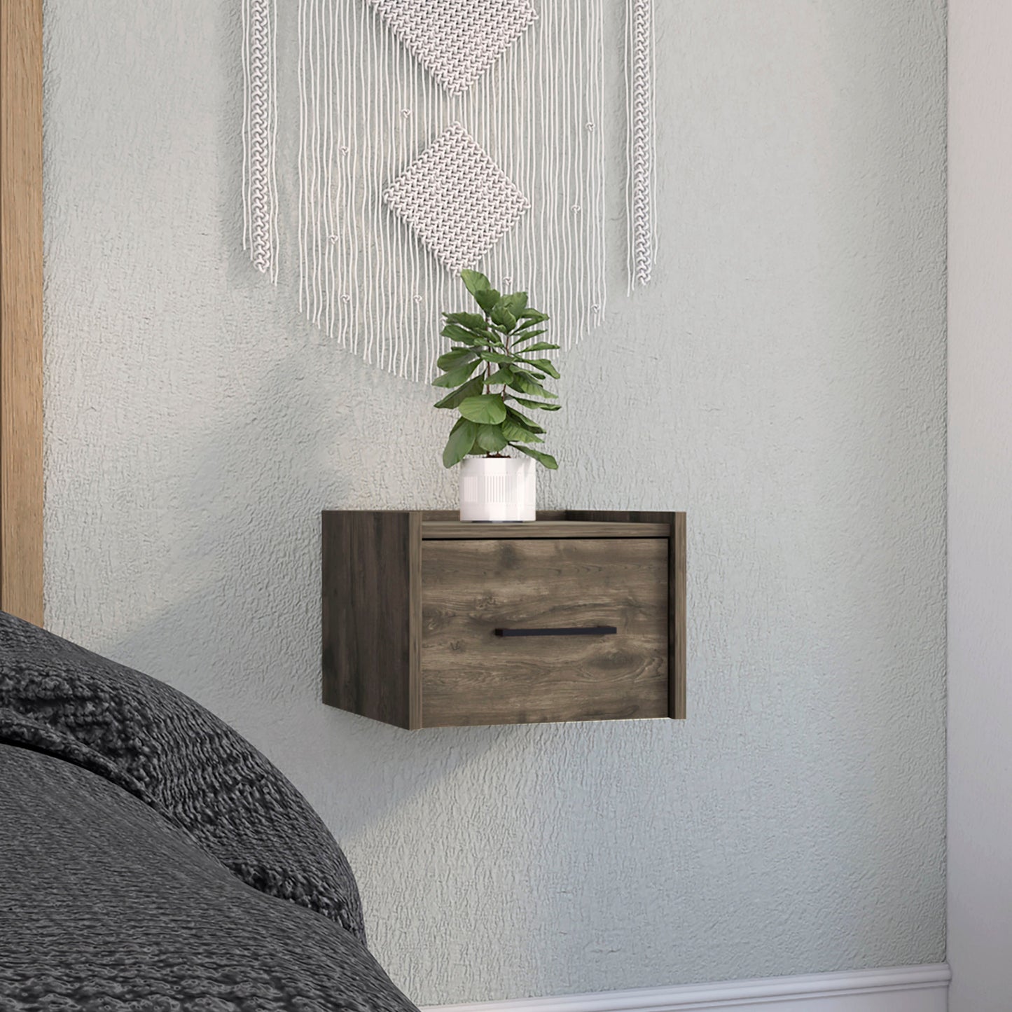 Floating bedside table in distressed wood finish with black handle and drawer