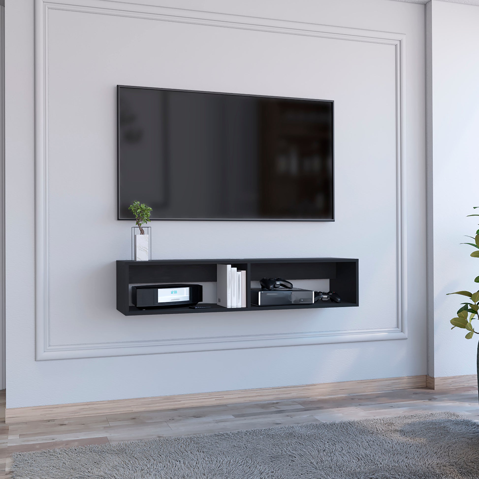 Black floating media console with two compartments holding electronics and books