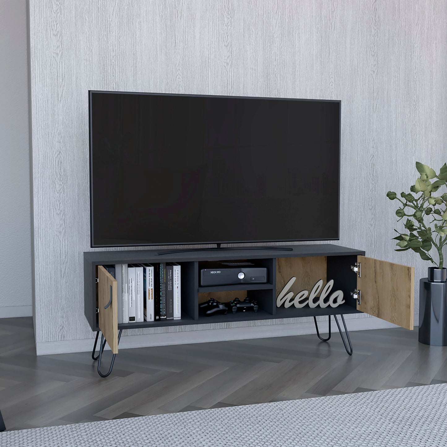 Dark gray TV stand with wood accents Xbox controllers and decorative hello sign