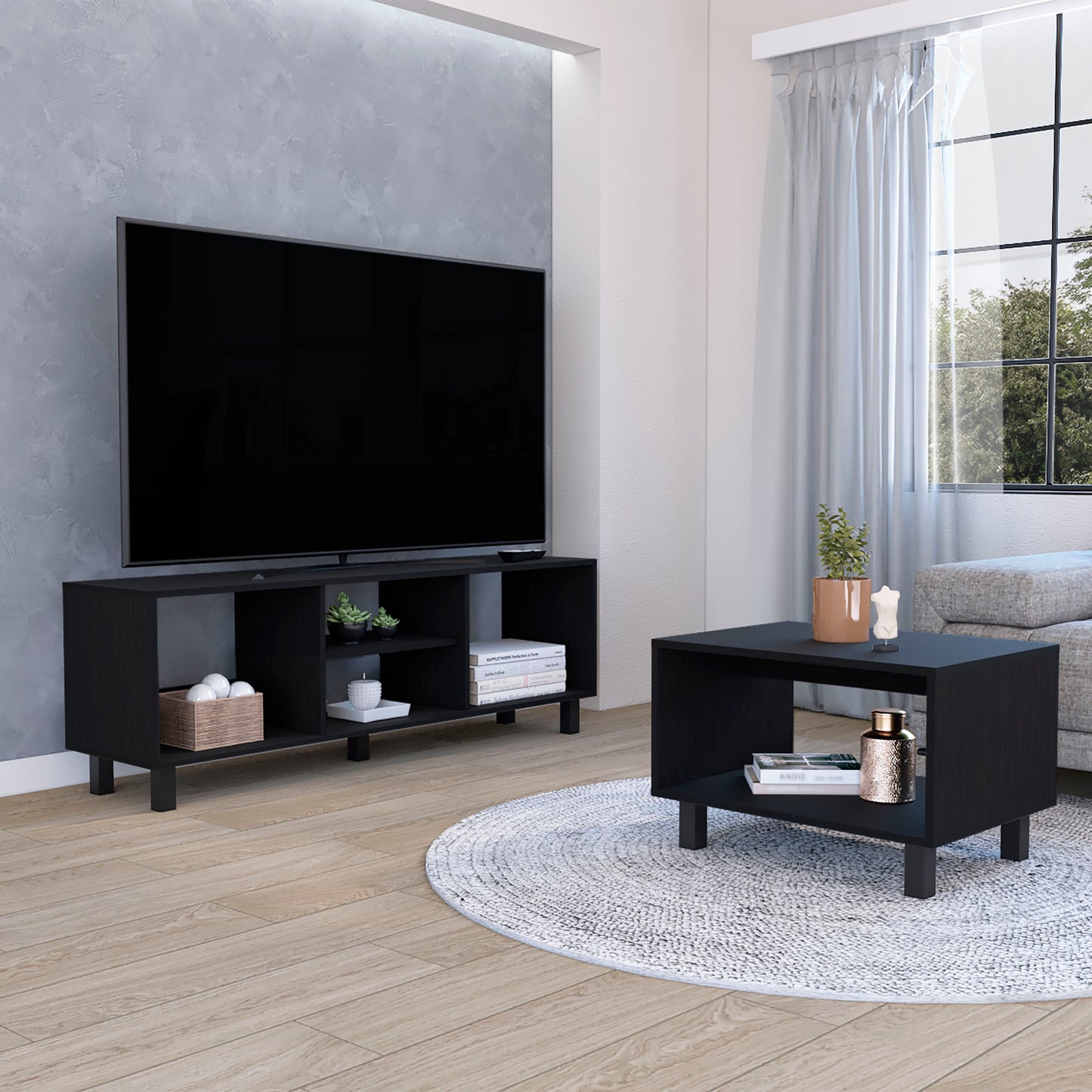 Black modern TV stand with open shelving and wooden basket of spheres