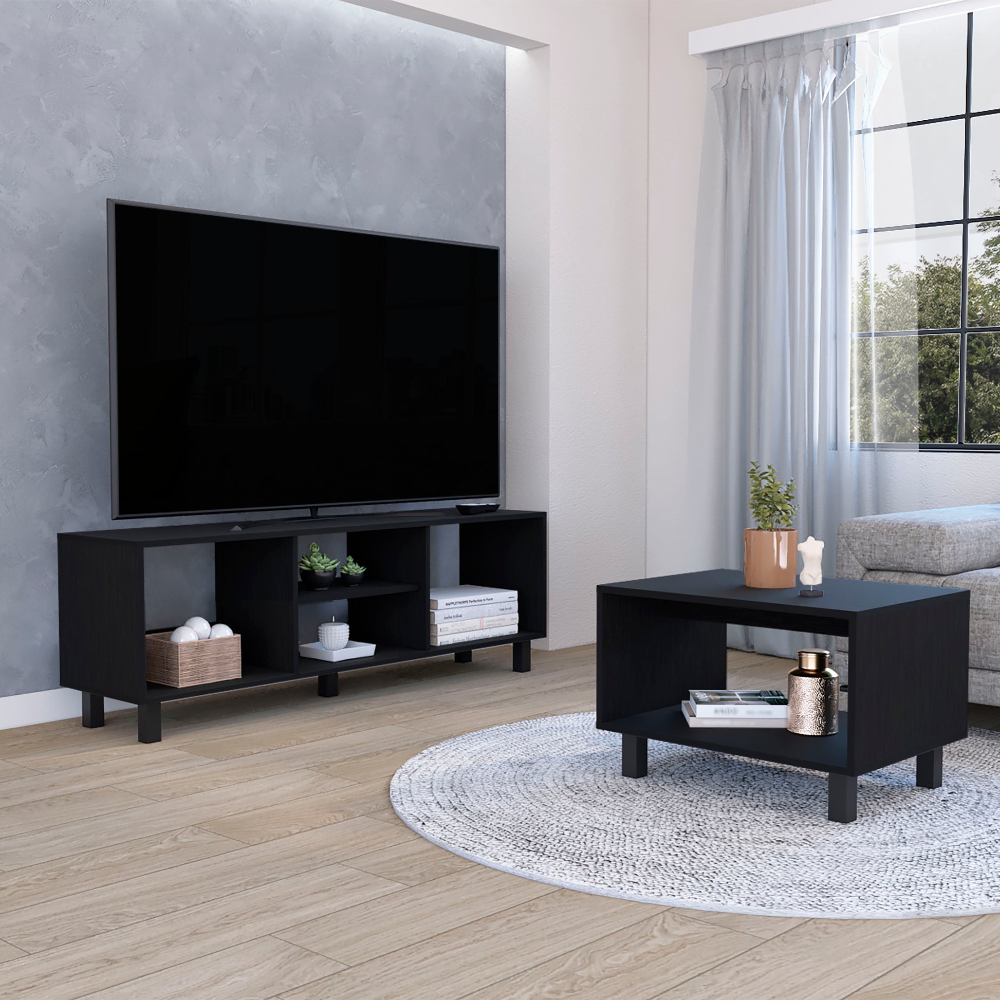 Black modern TV stand with open shelving and wooden basket of spheres